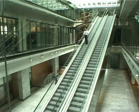 Man on an escalator 2 shots Stock Footage 72864