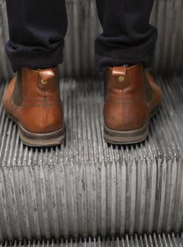 Man on escalator Stock Photos