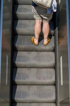 Man on escalator Stock Photos