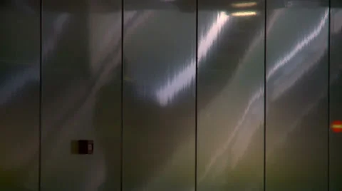 Man on escalator reflected by modern metalic wall of metro station Stock Footage 42400534