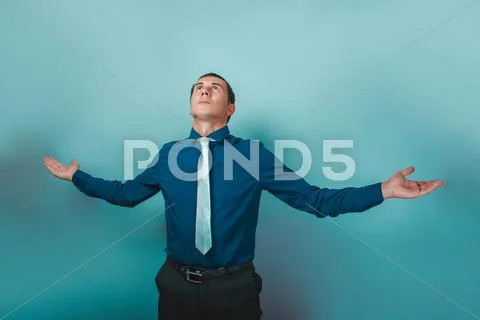 A man of European appearance thirty years spread his arms looki Stock Photos