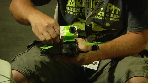 Man examine the drone before race Stock Footage 99050560