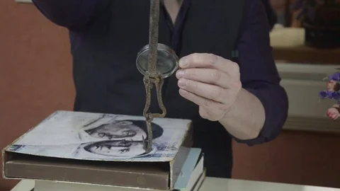 A man examines an ancient piece of iron Stock Footage 74195533