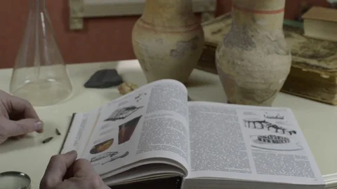 A man examines an antique tip from an arrow Stock Footage