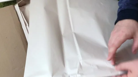 A man examines the elements of a computer desk before assembling. Picks up .. Stock Footage 236688913