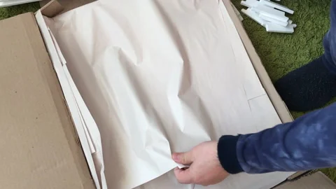 A man examines the elements of a computer desk before assembling. Takes the.. Stock Footage 236689222