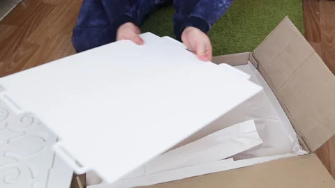 A man examines the elements of a computer desk before assembling. Takes the.. Stock Footage 236689256