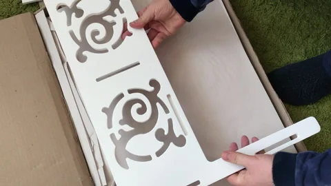 A man examines the elements of a computer desk before assembling. Takes up .. Stock Footage 236689283