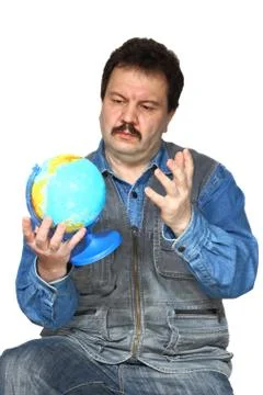 Man examines globe Stock Photos