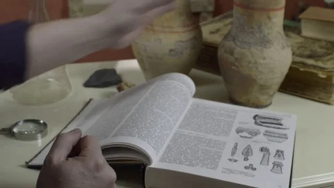 A man examines an old pitcher 스톡 동영상 74340102