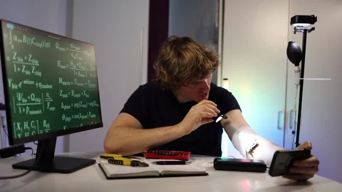 Man examining a glowing bio chip on his forearm with a small light Stock Footage 323271128