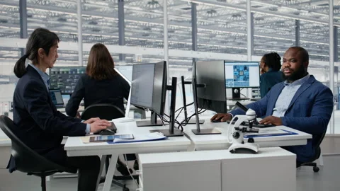 Man examining microchip circuit layouts on computer monitor in factory RD office Stock Footage 335880990