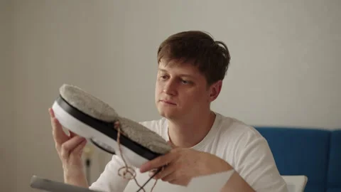 Man examining robot window cleaner, inspecting cleaning pads, accessories and Stock Footage 318467350