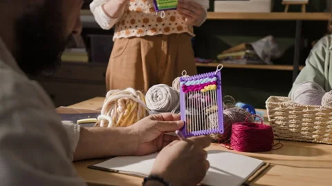 Man Examining Small Weaving Loom at Creative Craft Workshop Stock Footage 341948479