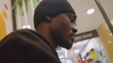 Man examining tablet in retail lounge. Determined male entrepreneur wearing Stock Footage 335307114