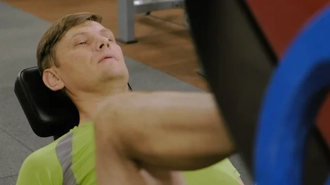 A man with excess weight doing leg presses on the simulator in the gym. Fitness Stock-Footage 111887798