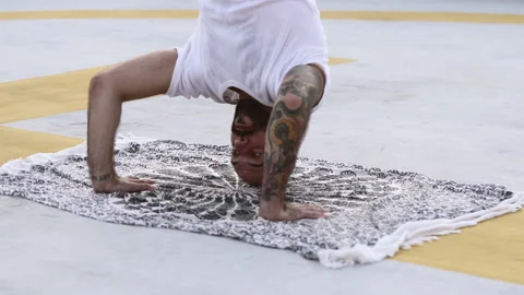 Man Executes Headstand As His Arms Supports His Body And Places His Legs Stock Footage 154953060