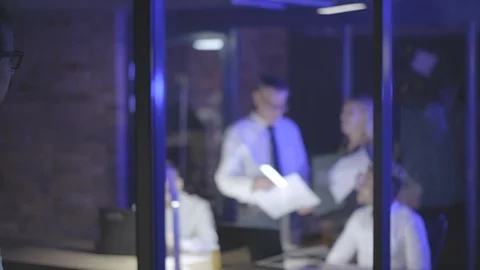Man executive supervising his workers in dark office. Stock Footage 125683015