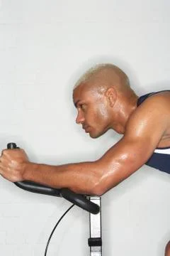 Man on Exercise Bicycle Stock Photos