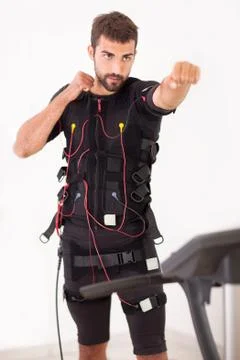 Man exercise on  electro muscular stimulation machine Stock Photos