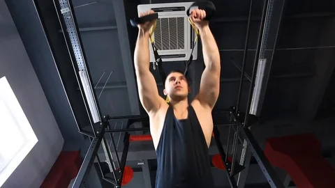 Man exercise at a gym by using bungee training Stockbeeldmateriaal 73933514