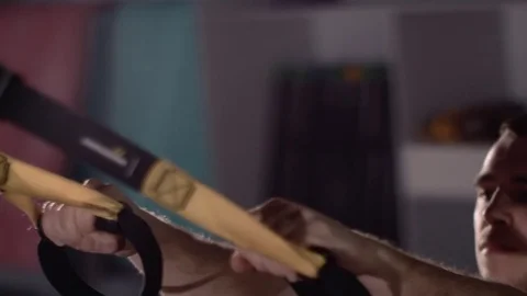 Man exercise at a gym by using bungee training Stockbeeldmateriaal 77326689