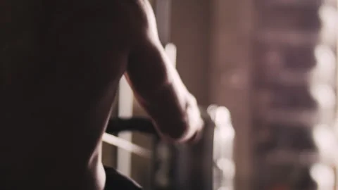 Man exercises on rowing machine indoors during daylight hours Stock Footage 312759518