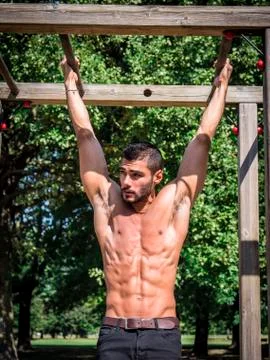 Man exercising and working out in outdoor gym Stock Photos