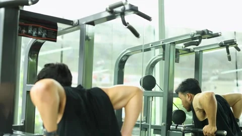 Man Exercising on Assisted Pull-Up Machine in Gym Stock Footage 325025387