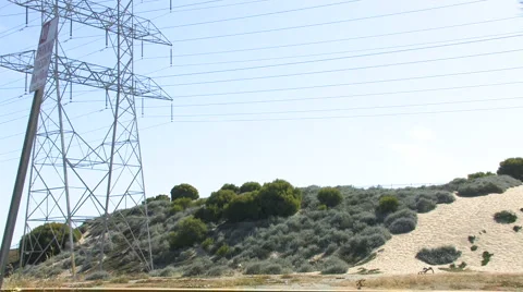 Man Exercising at the base of a Sand Dune near Power Tower Stock Footage 4280098