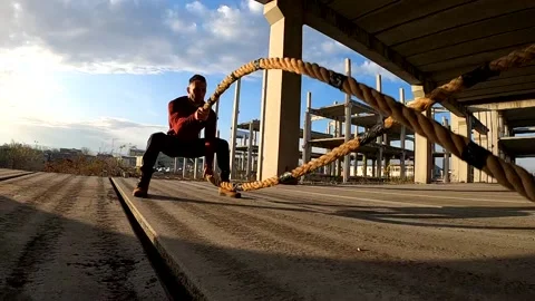 Man exercising with battle ropes Stock Footage 134692278