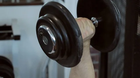 Man exercising biceps in a gym Video stock 97706362