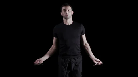Man exercising on black background with skipping rope Vídeo Stock 32957529