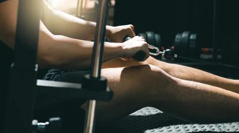 Man exercising on cable machine, strengthening body in gym. Foto stock