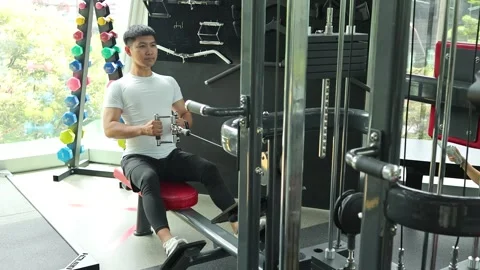 Man Exercising on Cable Row Machine in Gym Stock Footage 326849417