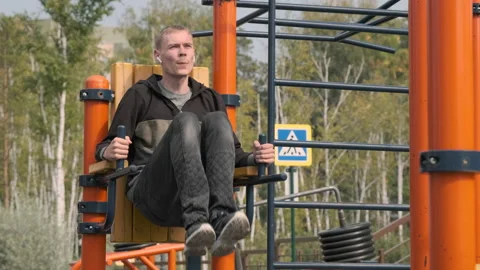 Man Exercising on Chest Press Machine Outdoors Stock Footage 160400521