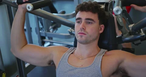 Man Exercising on Chest Press Machine in Gym Stock Footage 323774206