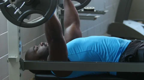 Man Exercising, Doing the Bench Press in the Gym, Static shot Stock Footage 49100363