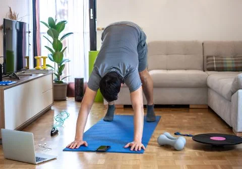 Man exercising doing workout at home Stock Photos