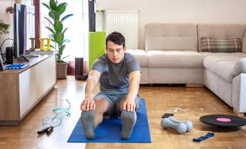 Man exercising doing workout at home Stock Photos