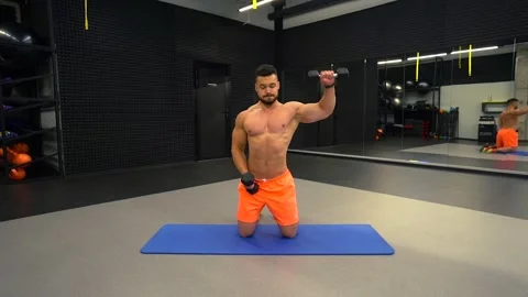 Man exercising with dumbbells in the gym Stock Footage 211653076