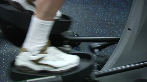 Man exercising on elliptical machine Stock Footage 54592680