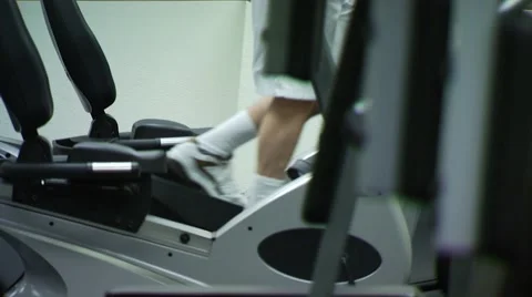 Man exercising on elliptical machine in gym Stock Footage 54592676