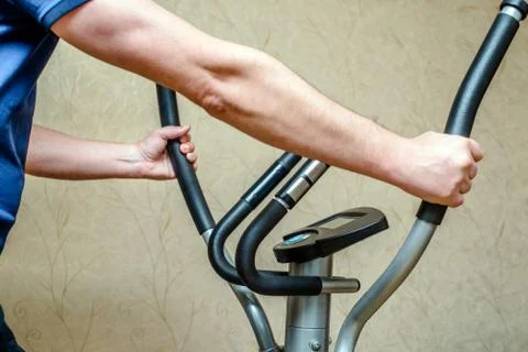A man exercising on elliptical trainer machine 写真素材