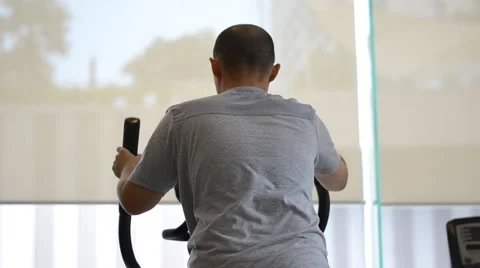 Man exercising elliptical treadmill trainer Stock Footage 51510408