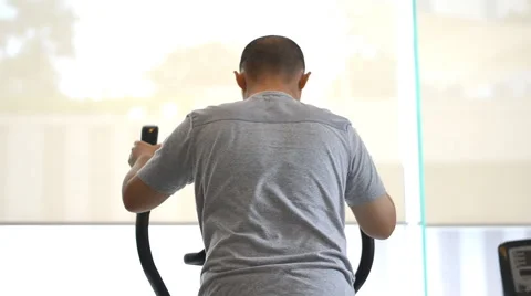 Man exercising elliptical treadmill trainer Stock Footage 51526327
