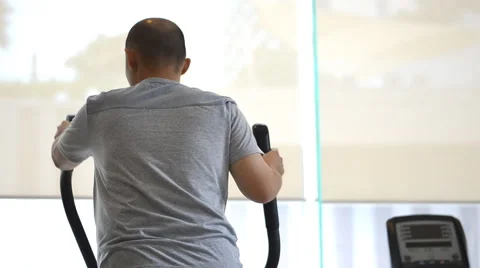 Man exercising elliptical treadmill trainer Stock Footage 51548321