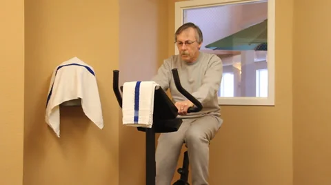 Man exercising on an exercise bike Stock Footage 33819751