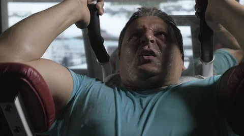 Man exercising hard on strength training machine in the gym Video stock 63129505