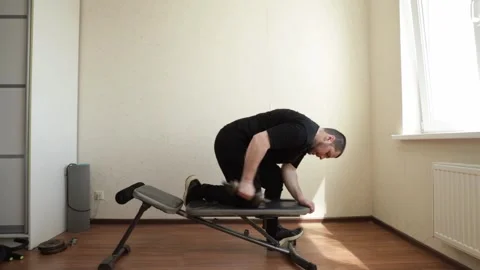 Man exercising in home gym, training to build a strong physique, dedicated .. Stock Footage 286097258